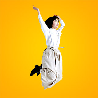 Middle-aged woman jumping in the air