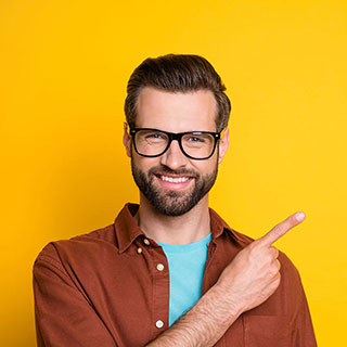 Man confidently smiling while pointing at something.
